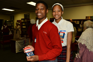Two students showing off “What it says, What it Means” a pocket guide to the constitution which was donated by Rawle and Henderson and given to all the student participants. 