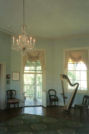 A harp stands in the beautiful Octagon Room of Laurel Hill Mansion wjhere the music series Concert by Candlelight is hosted.
