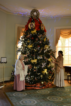 Volunteers in colonial costumes decorating the tree for the 2018 holiday season at Laurel Hill Mansion