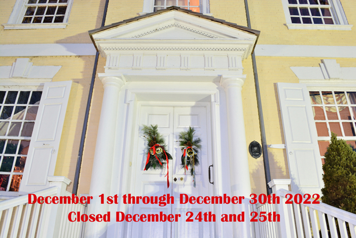 A detail of the facade of Laurel Hill Mansion with the dates of the public 2023 holiday tours