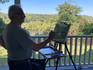 A participant in the Fall 2022 Plein Air painting workshop given at Laurel Hill Mansion by artist Joe Sweeney